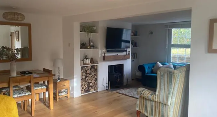A living room filled with furniture and a fire place.