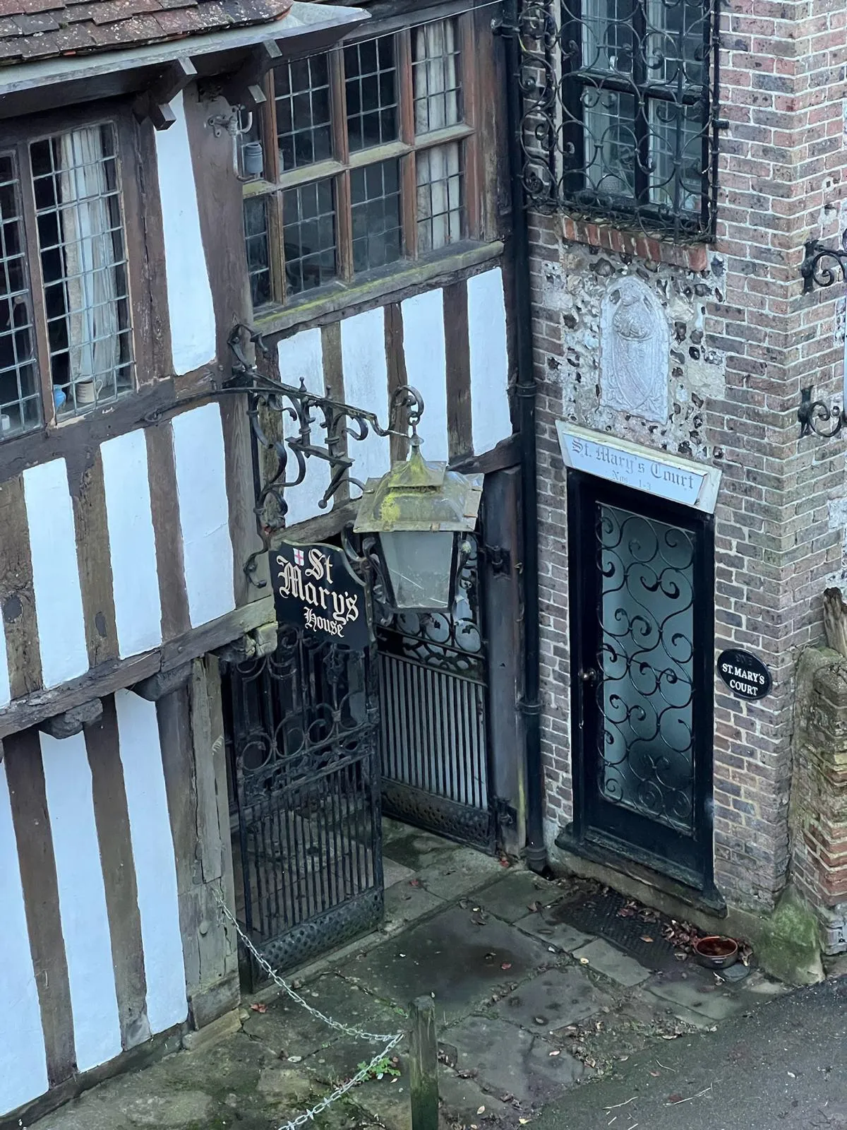 An old building with a gate and a street light.