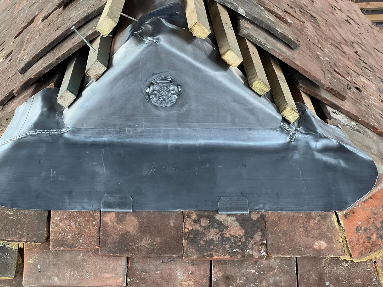 The roof of a building with a metal roof vent.