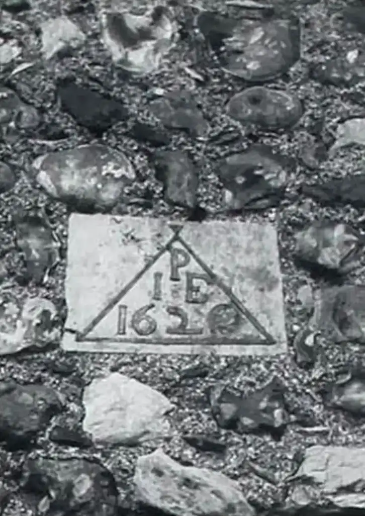 A stone wall with a sign on it.