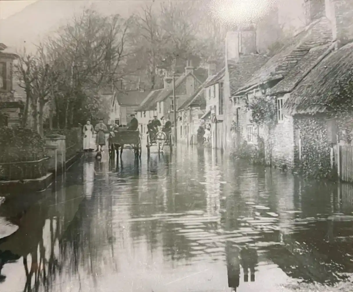 A black and white photo of a flooded street.
